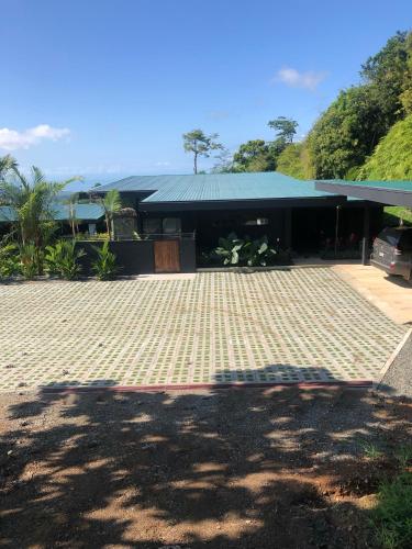 a building with a brick driveway in front of it at Cielo Rojo in Savegre