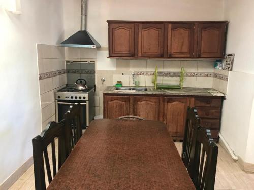 a kitchen with a table and chairs and a stove at Hospedaje Elias in Tilcara