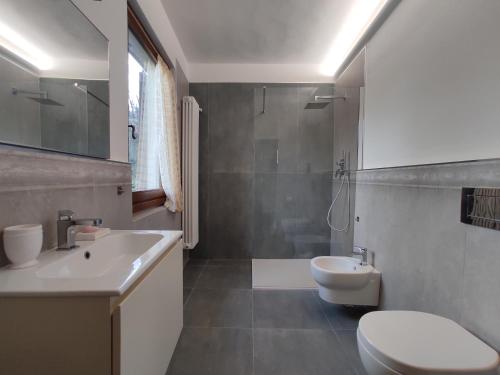a bathroom with a white toilet and a sink at Villa Le Balze in Reggello