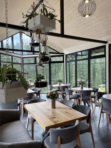 a restaurant with tables and chairs and windows at Шишка in Bukovel