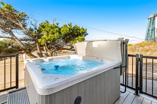 a hot tub on the deck of a house at The Boat House Retreat in Lincoln City