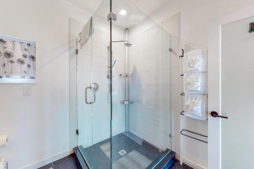 a shower with a glass door in a bathroom at Lake Washington Adventures in Seattle