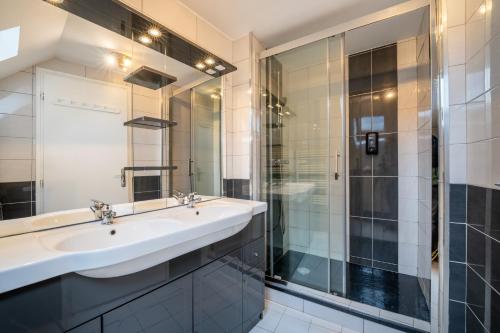 a bathroom with a sink and a shower at La bergerie in Azet