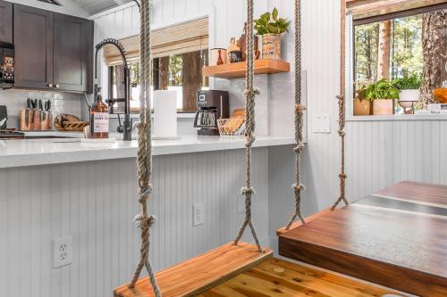 a swing in a kitchen with a wooden floor at Gorgeous Serenity in Pinetop-Lakeside