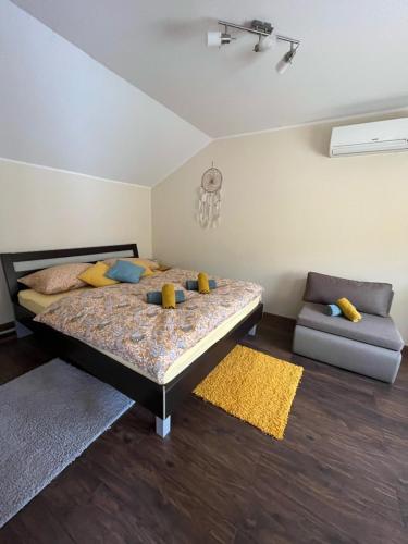 a bedroom with a bed and a couch at Kuća - Na Granici in Ilok