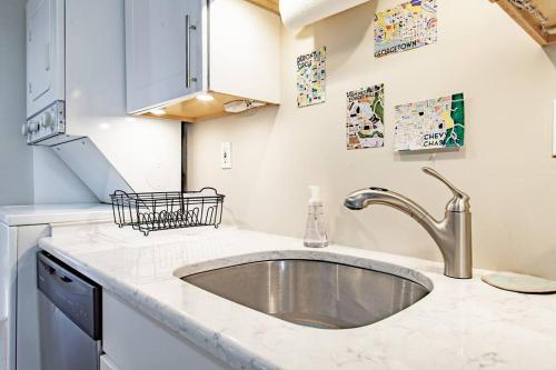 a kitchen with a sink and a counter top at Bright Top Floor On Georgetown Cobblestone Street in Washington, D.C.