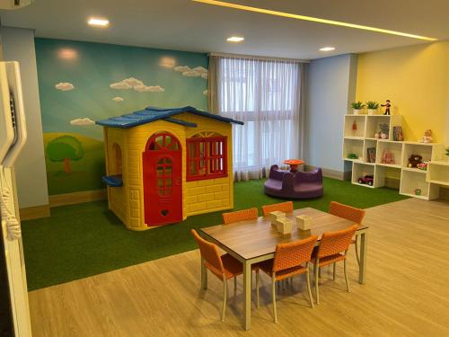 a play room with a table and a play house at One way in João Pessoa
