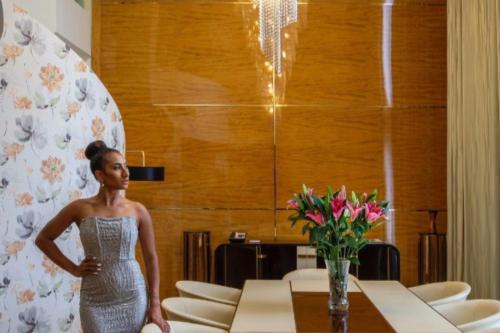 a woman in a silver dress standing next to a table at Airways Hotel in Port Moresby