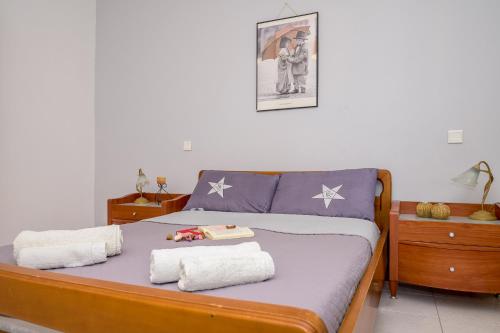 a bedroom with a bed with two towels on it at City Melody Apartment with Private Parking in Alexandroupoli