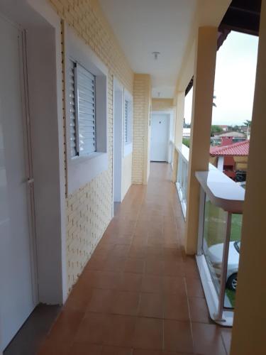 a corridor of a house with a balcony at Pousada Aconchego in Ilha Comprida