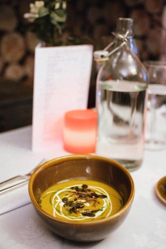 a bowl of food on a table with a bottle at Laburnum Guest House at Bistro En Glaze in Wylam