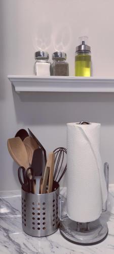 a kitchen counter with a roll of paper towels and utensils at Bonito departamento remodelado tranquilo y centrico in Ciudad Juárez