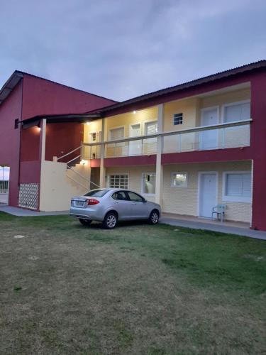 a car parked in front of a building at Pousada Aconchego in Ilha Comprida