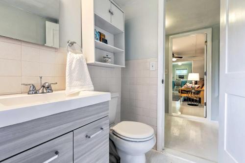 a white bathroom with a toilet and a sink at Cozy OBrien Home with Fire Pit and Patio Near Rivers! in Branford