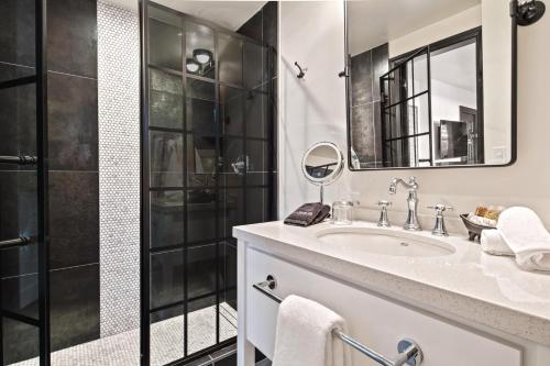 a bathroom with a sink and a shower at Bespoke Inn Flagstaff in Flagstaff
