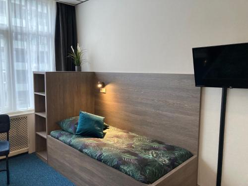 a hotel room with a couch in a room at Hotel Poseidon in Scheveningen