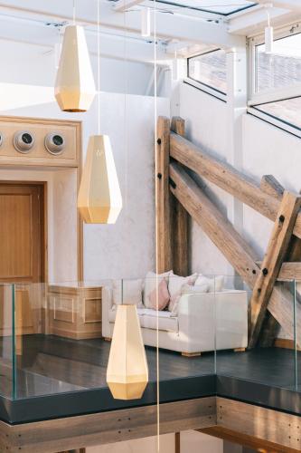 a living room with a white couch and some lights at Hôtel Chais Monnet & Spa in Cognac