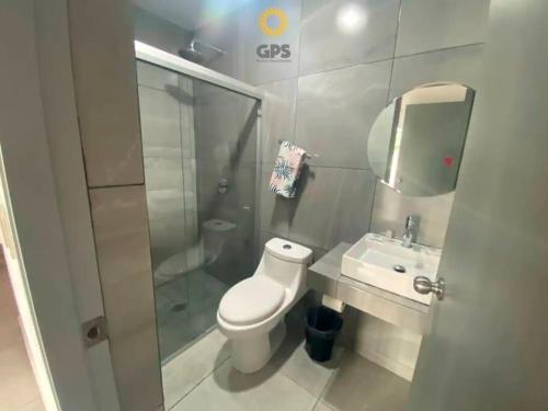 a bathroom with a toilet and a sink and a shower at hermoso depa con vista a la marina by G P S rentas in Mazatlán