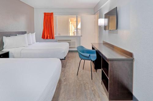 a hotel room with two beds and a desk at Motel 6-Lancaster, CA in Lancaster