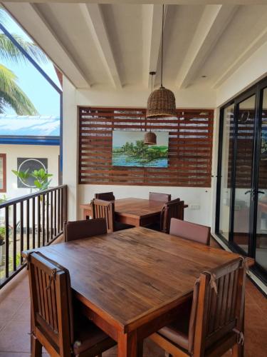 a dining room with a wooden table and chairs at Wellé Wadiya Beach Villa in Kalpitiya