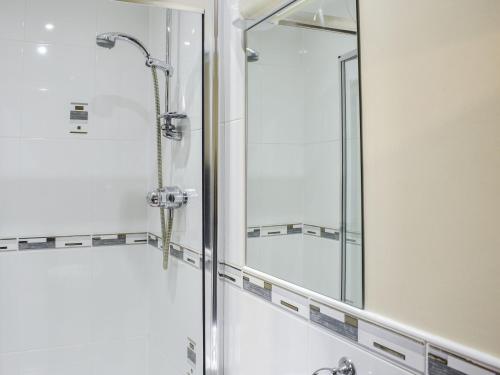 a shower in a bathroom with a glass door at Mount Cottage-uk42230 in Low Borrowbridge