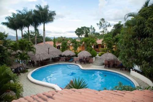 a view of a swimming pool at a resort at Apart Hotel Acuarious de Luis in Estelí