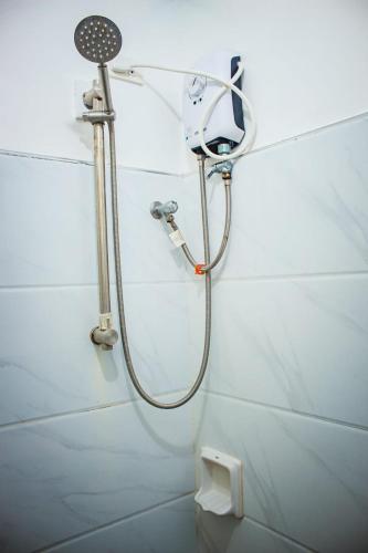 a shower in a bathroom with a toilet at HAVEN BREEZE RESORT - A home of Hundred Islands in Alaminos