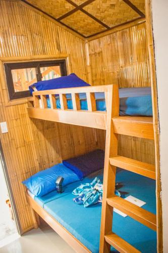 a bunk bed in a boat with a bunk bed in it at HAVEN BREEZE RESORT - A home of Hundred Islands in Alaminos