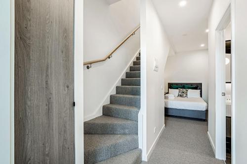 a staircase leading to a bedroom in a house at Lumina Suites in Melbourne