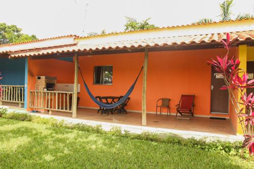 a hammock on the porch of a house at Pousada do Dinho in Esmeraldas