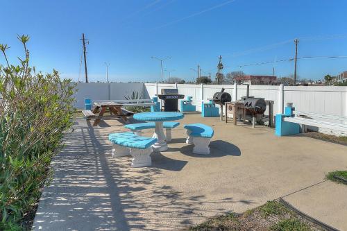 a group of picnic tables and benches on a patio at Fairways #204 in Padre Island