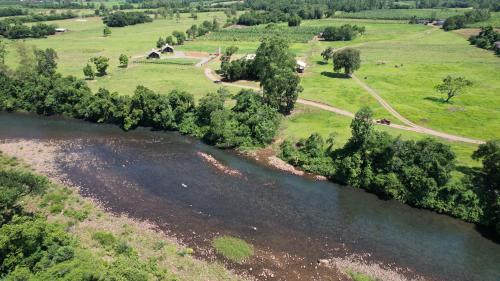 an aerial view of a river with grass and trees at Vicença Glamping in Praia Grande