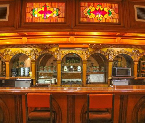 a bar with stained glass windows in a restaurant at Hacienda El Galeon in Ensenada