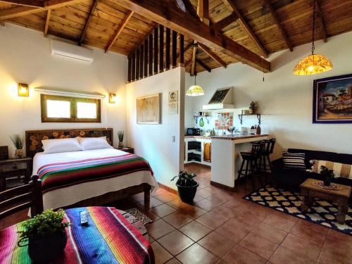 a bedroom with a bed and a desk in a room at Hacienda El Galeon in Ensenada