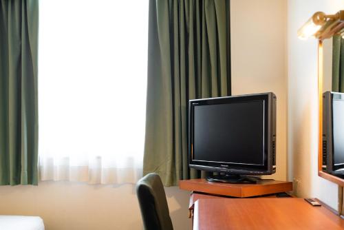 a television sitting on a table in a hotel room at Plaza Hotel Premier in Fukuoka