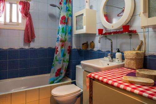 a bathroom with a toilet and a sink and a mirror at Casa Su, precioso apartamento en complejo con piscina in Puerto del Carmen