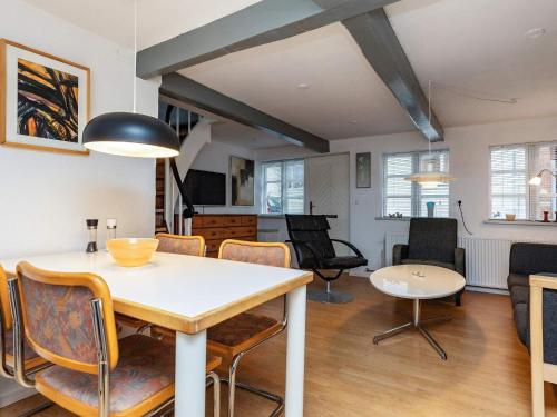 a dining room and living room with a table and chairs at 4 person holiday home in Rudkøbing-By Traum in Rudkøbing