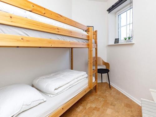 a bedroom with two bunk beds and a desk at 5 person holiday home in Bogense-By Traum in Bogense