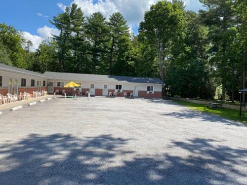 a large parking lot in front of a building at Three Island Motel in Bobcaygeon