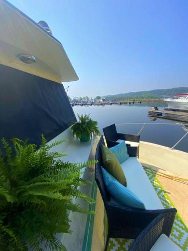 a balcony with a couch and a view of the water at The Lily Pad Boatel Houseboat in Savanna