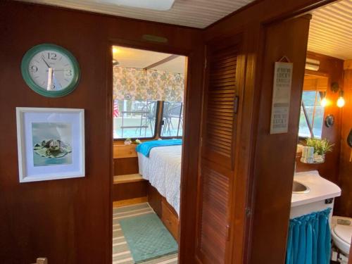 a bedroom with a bed and a clock on the wall at The Lily Pad Boatel Houseboat in Savanna