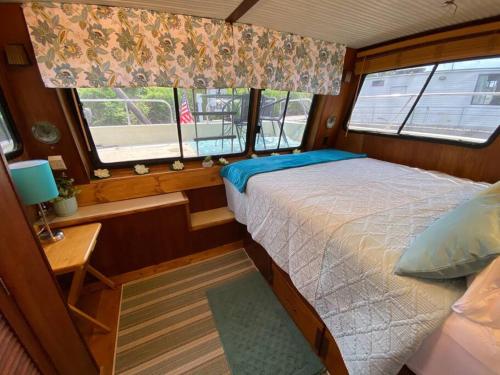 a bedroom in a boat with a bed and a window at The Lily Pad Boatel Houseboat in Savanna