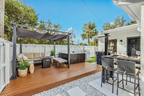 a backyard with a hot tub and a grill at * NEW* The Bungalow Jupiter! - Moremoments Rentals in Jupiter