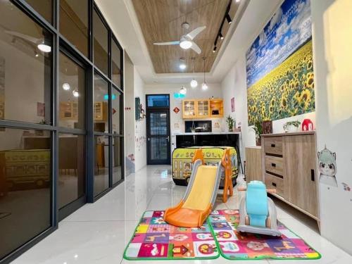 a childs room with a slide and a bed at Beauty Chen's House #3 in Tianwei