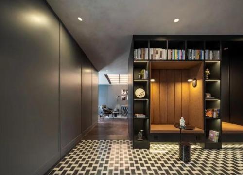 a hallway with a book shelf with a clock on it at Mia Hotel - Shanghai Shaanxi South Road in Shanghai