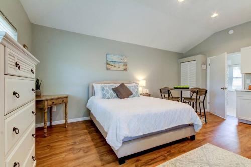 a bedroom with a bed and a dining room with a table at Beautiful Studio in Downtown Dunedin! in Dunedin