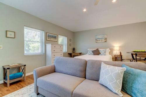 a bedroom with a bed and a couch at Beautiful Studio in Downtown Dunedin! in Dunedin