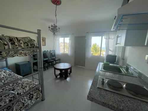 a kitchen and a living room with a bunk bed at Loft 208 in Acapulco