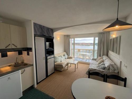 une cuisine et un salon avec vue sur l'océan dans l'établissement Appartement 4 pers. avec terrasse, piscine, parking - FR-1-379-153, à Vieux-Boucau-les-Bains