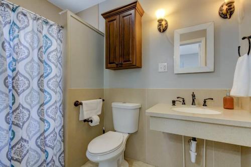 a bathroom with a toilet and a sink at Light & Bright! Quaint Downtown Dunedin Bungalow! in Dunedin